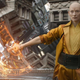 Tilda Swinton's bald Ancient One in yellow robes wielding see-through orange magic in one hand.